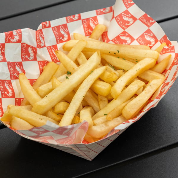 Golden french fries in a red and white checkered paper tray with the EbiNomi logo.