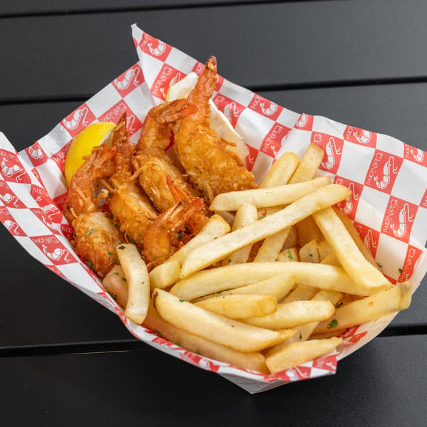 EbiNomi fried shrimp and french fries with a lemon wedge in a red and white checkered basket.